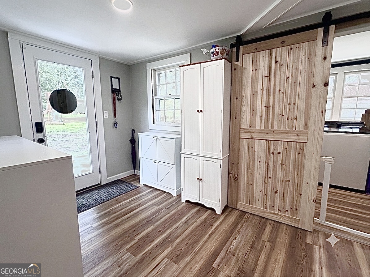 30 Church Street Carnesville, GA 30521 - Photo 15 of 15 a view of a kitchen with white cabinets and wooden floor