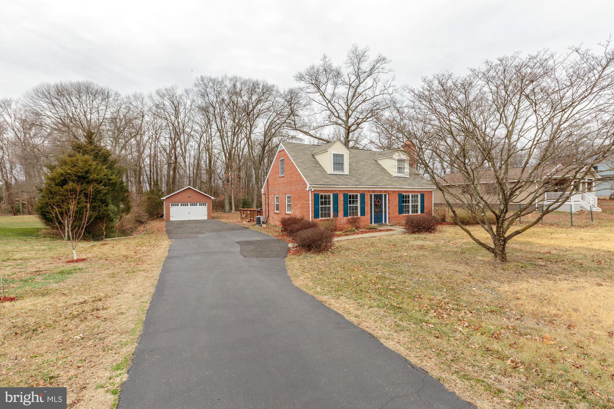 7004 Ridgeway Drive Springfield, VA 22150 - Photo 2 of 28 a view of a large white house with a yard covered with snow in the background