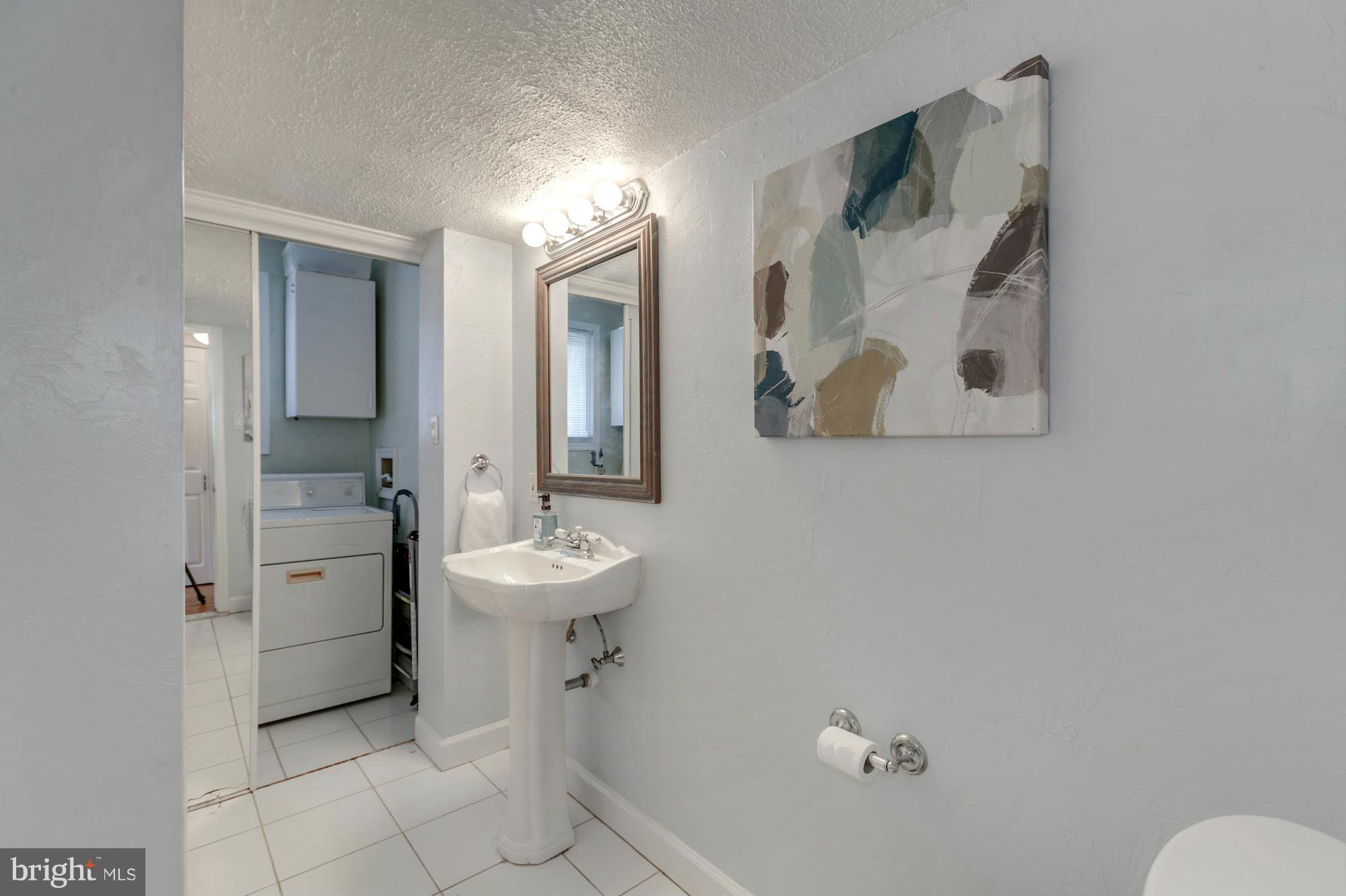 7004 Ridgeway Drive Springfield, VA 22150 - Photo 18 of 28 a bathroom with a toilet sink and mirror