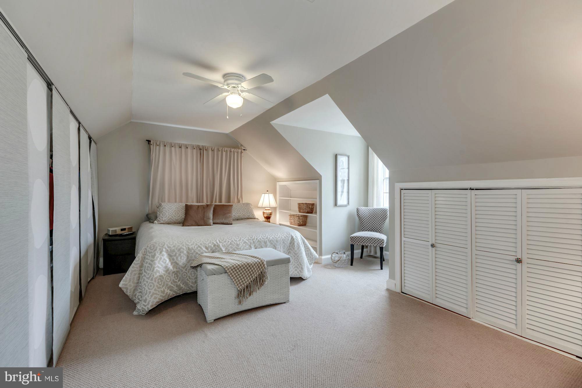 7004 Ridgeway Drive Springfield, VA 22150 - Photo 20 of 28 a spacious bedroom with a bed and lamp
