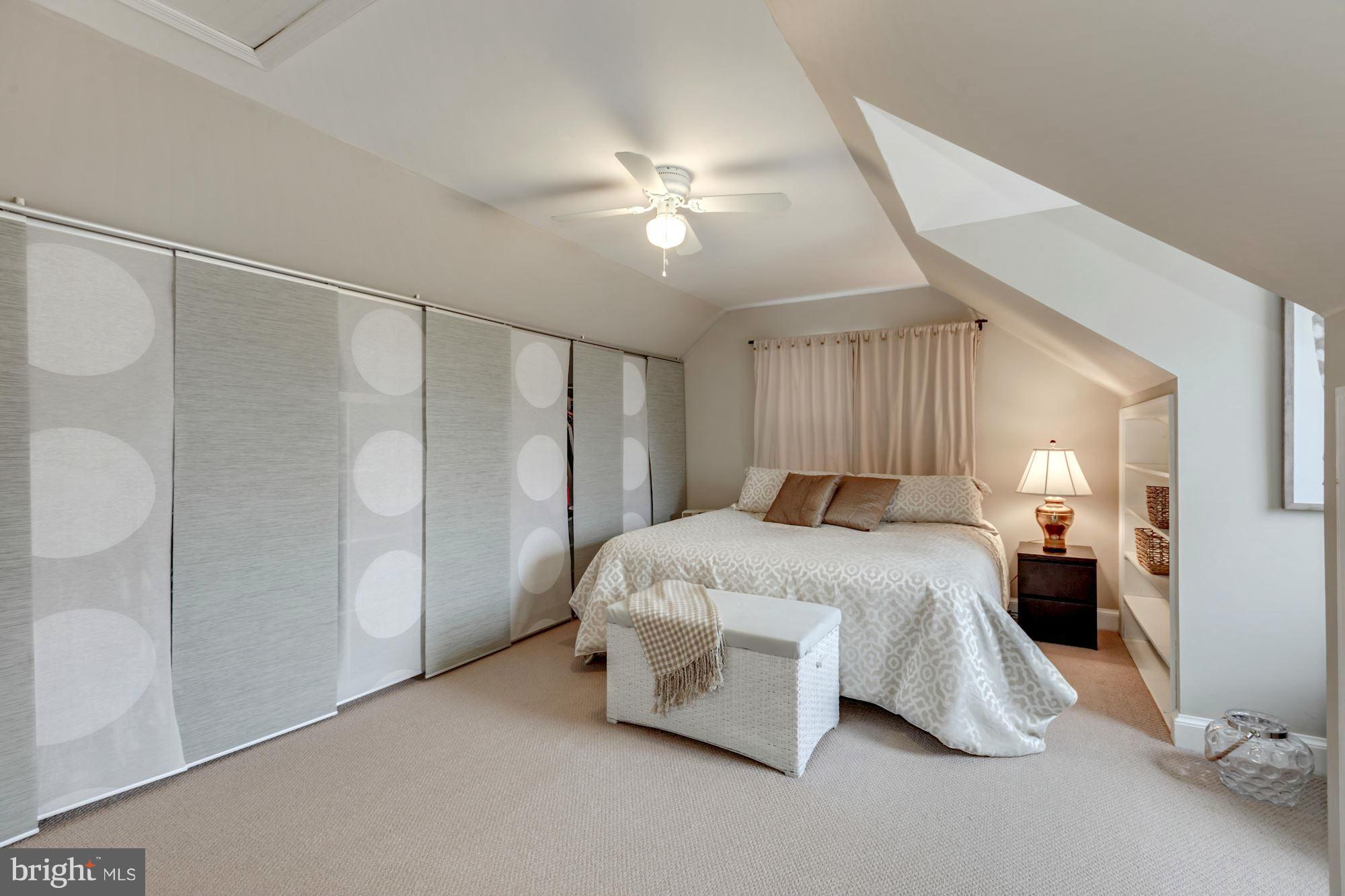 7004 Ridgeway Drive Springfield, VA 22150 - Photo 21 of 28 a spacious bedroom with a bed and a chandelier