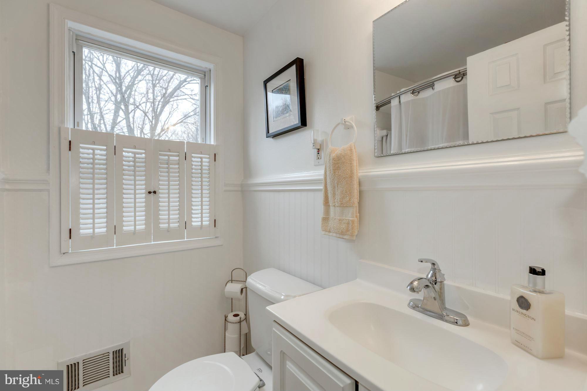 7004 Ridgeway Drive Springfield, VA 22150 - Photo 25 of 28 a bathroom with a sink mirror and toilet