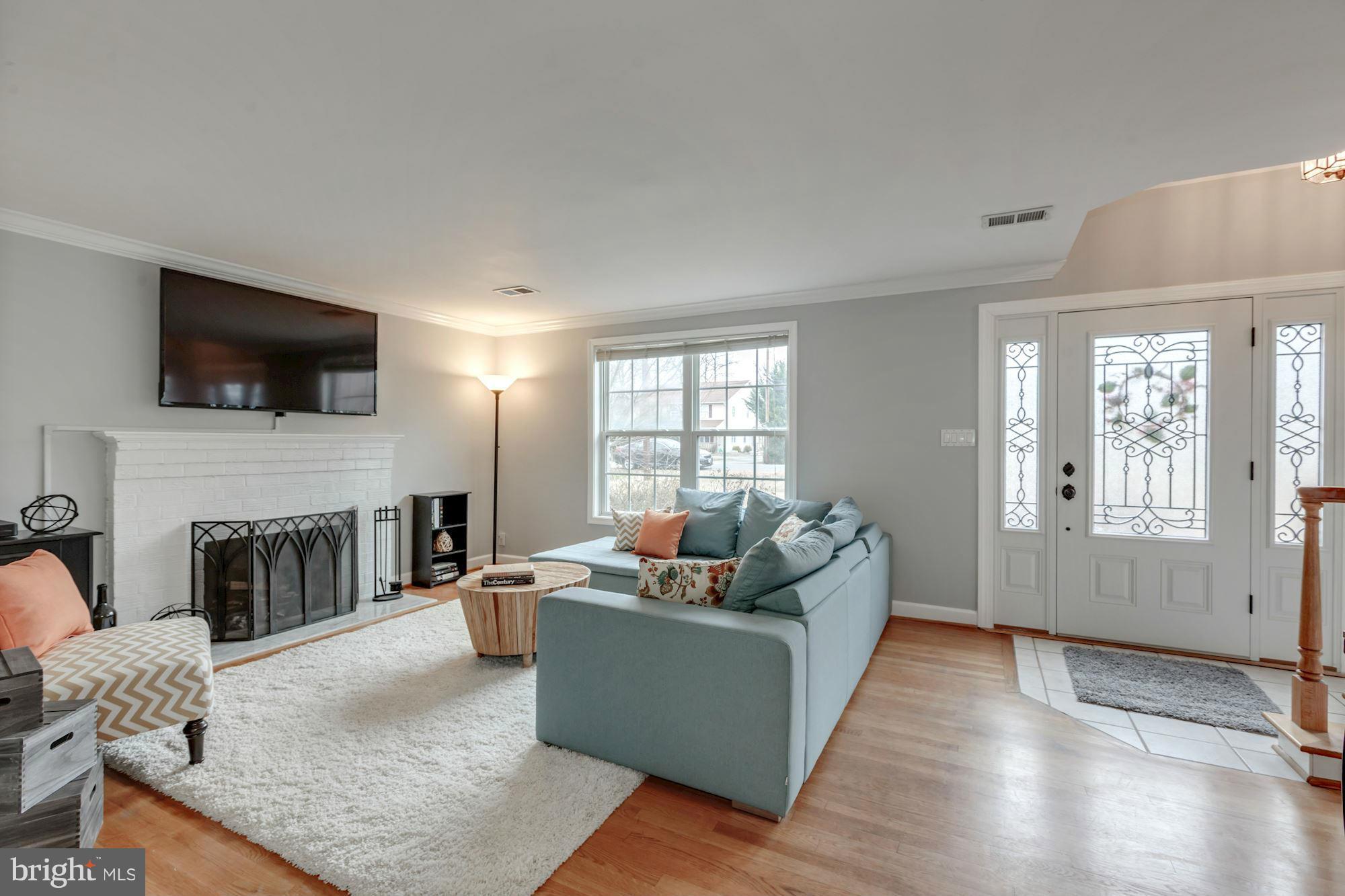 7004 Ridgeway Drive Springfield, VA 22150 - Photo 4 of 28 a living room with fireplace furniture and a flat screen tv