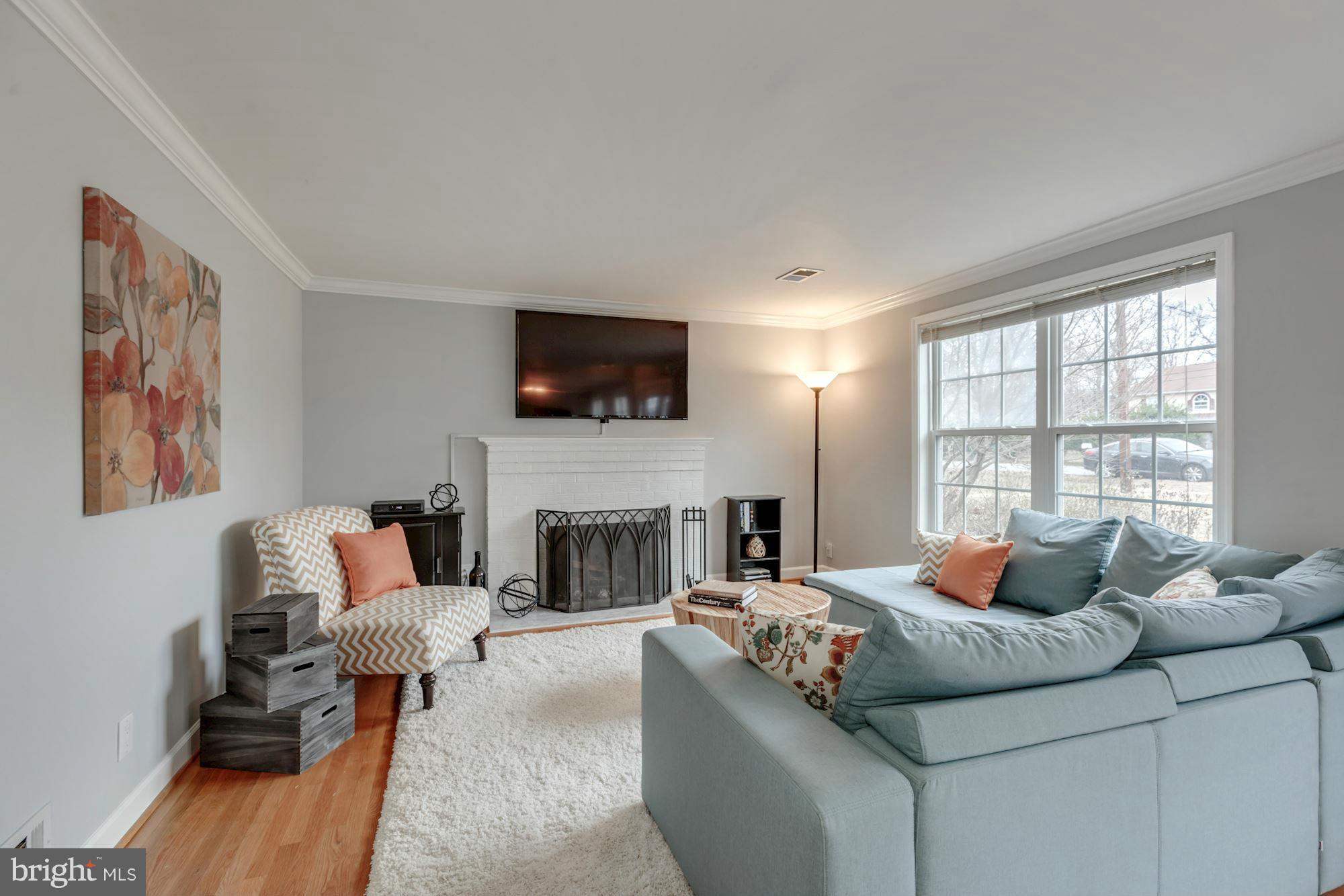 7004 Ridgeway Drive Springfield, VA 22150 - Photo 5 of 28 a living room with furniture fireplace and a flat screen tv