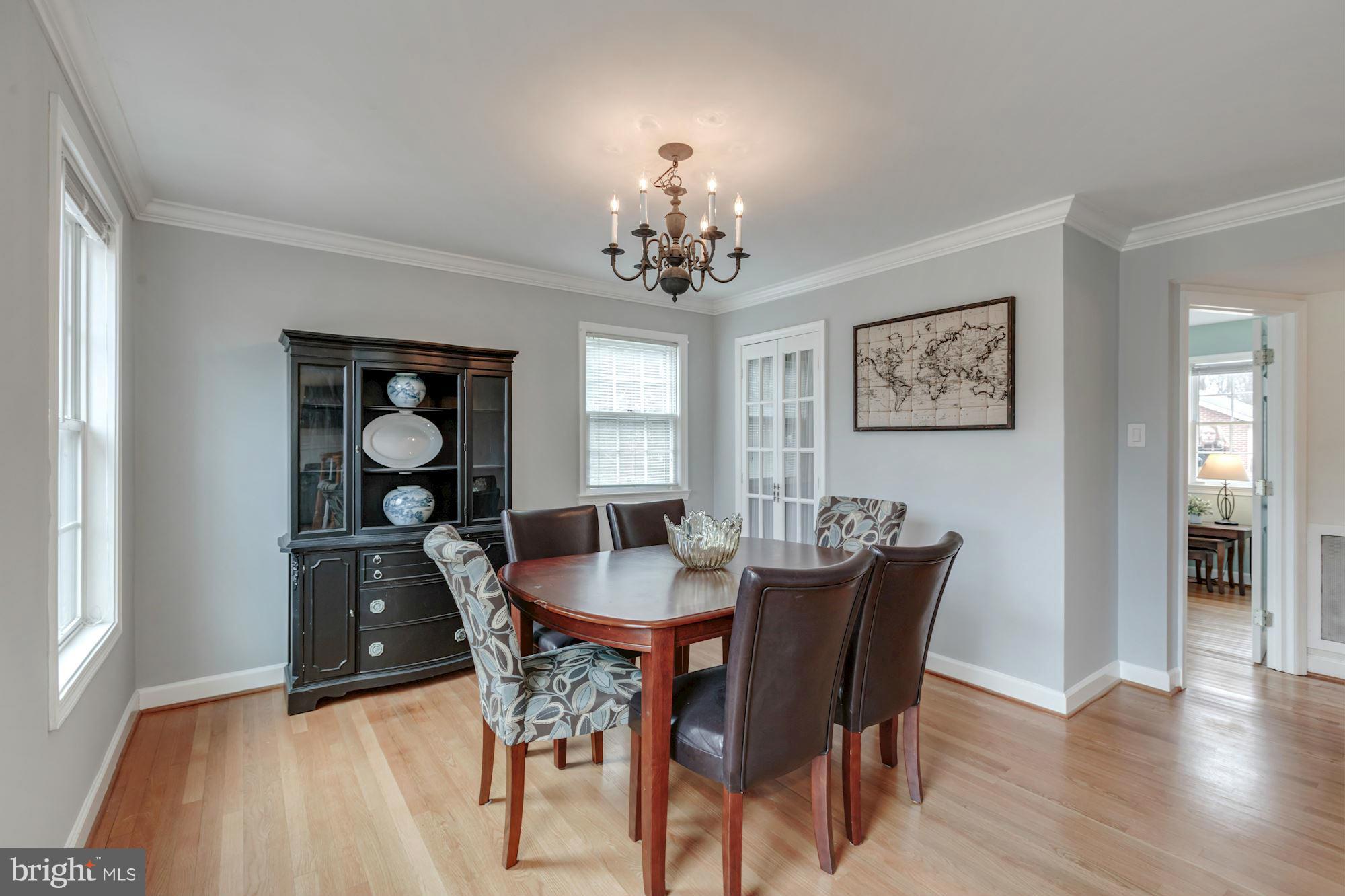 7004 Ridgeway Drive Springfield, VA 22150 - Photo 10 of 28 a dining room with furniture a chandelier and wooden floor