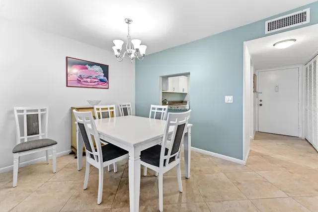 a view of a dining room with furniture and a chandelier