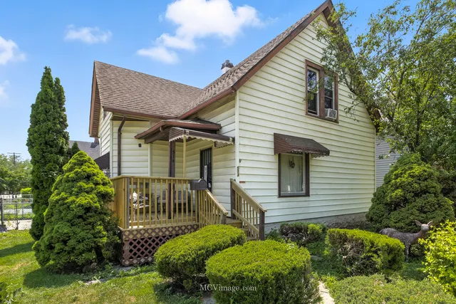 a view of a house with brick walls and flower plants