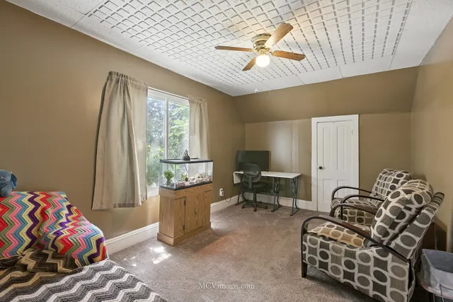 a bedroom with furniture and a window