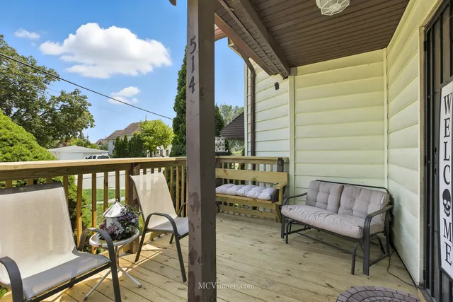 a view of balcony with wooden floor and outdoor seating