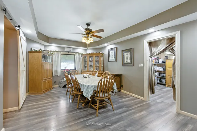 a view of a a dining room with furniture window and wooden floor