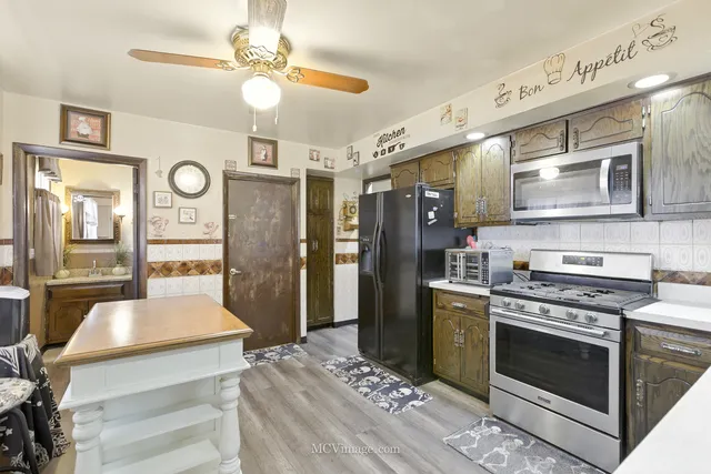 a kitchen with cabinets and stainless steel appliances