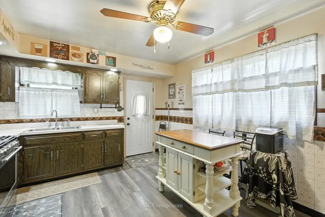 a kitchen with a stove a sink and a refrigerator
