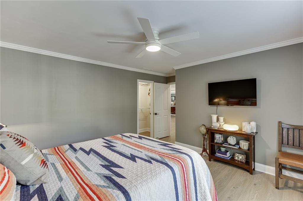 2758 Pathview Drive Dacula, GA 30019 - Photo 26 of 48 a bedroom with a bed and a flat screen tv