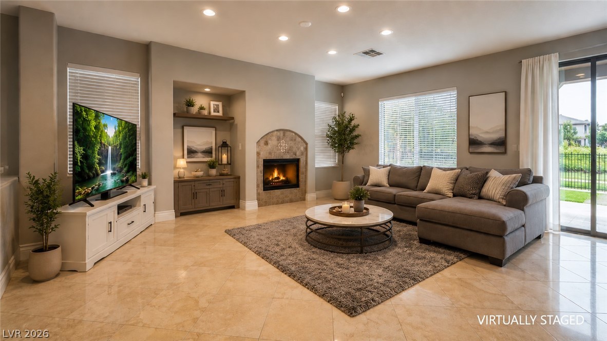 87 Tall Ruff Drive Las Vegas, NV 89148 - Photo 45 of 71 Recessed lighting illuminates this bright living room, featuring a built-in fireplace and direct outdoor access.