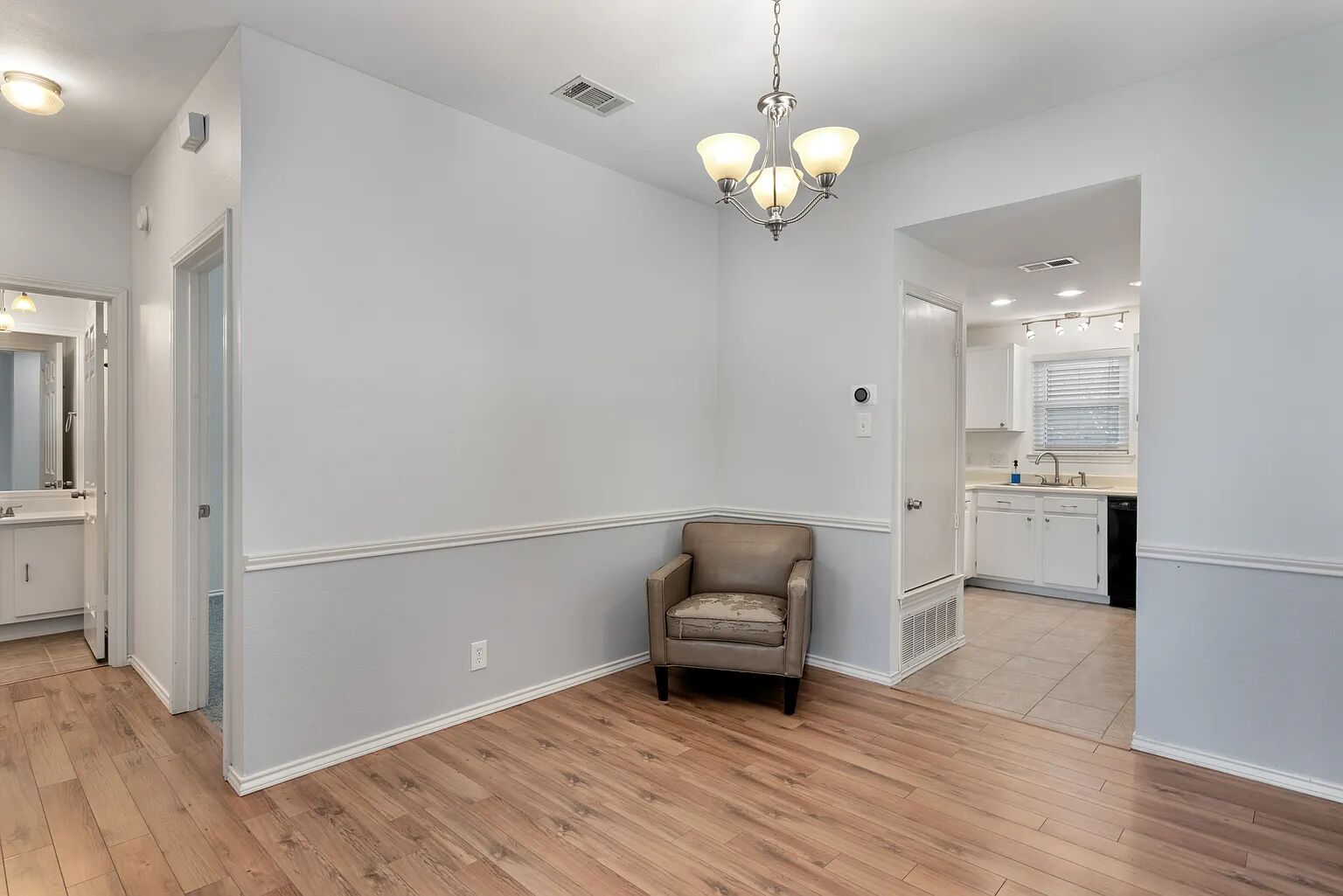 11970 Jollyville Road, Unit 202 Austin, TX 78759 - Photo 6 of 25 An inviting dining space with warm wood floors connects seamlessly to a well-appointed kitchen.