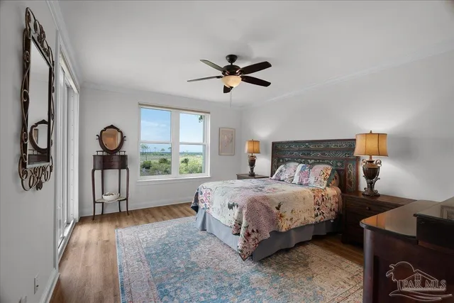 a bedroom with a bed chandelier and a window