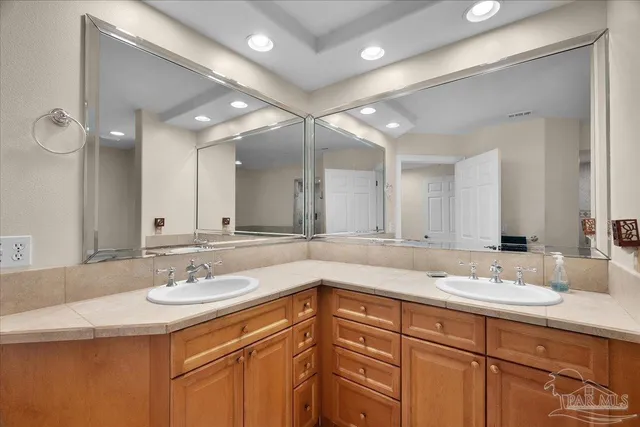 a bathroom with a sink double vanity and a mirror
