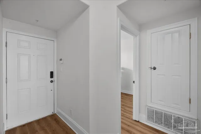 a view of a hallway with wooden floor