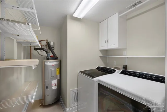a view of storage and utility room with washer and dryer