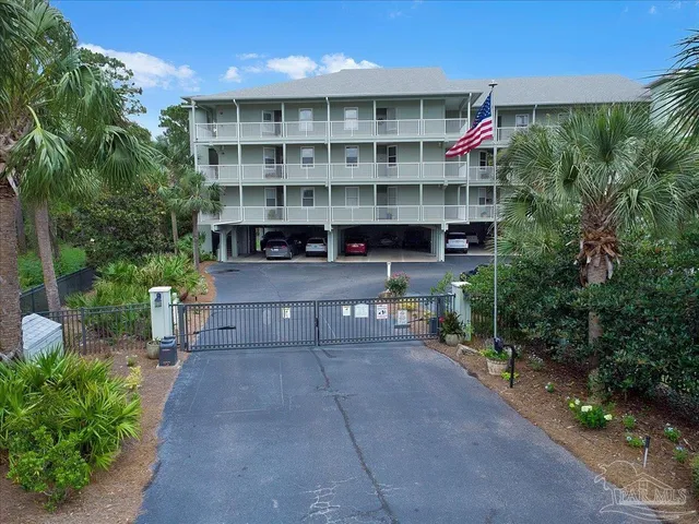 a view of a chairs and table in the back yard of the house