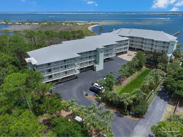 an aerial view of a house with a yard and lake view