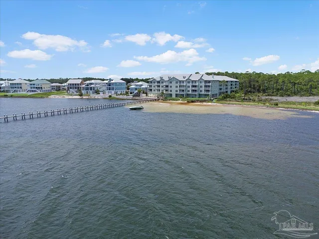 a view of a lake with houses in the background