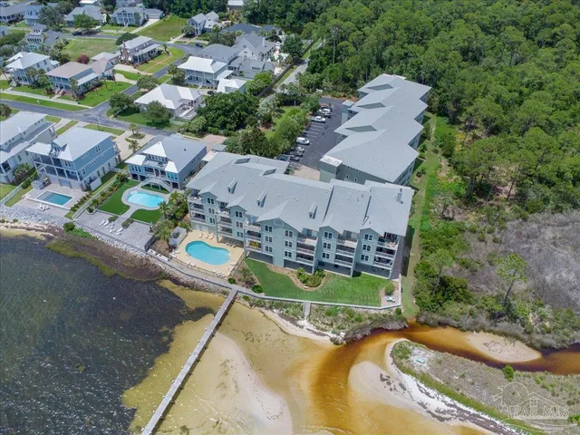 an aerial view of a swimming pool with a yard