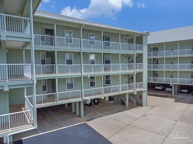 a large building with a bench and a barbeque