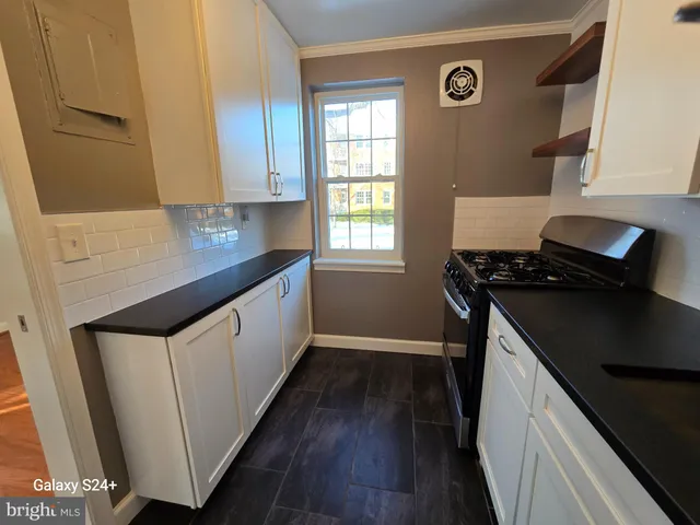 a kitchen with a refrigerator stove and cabinets