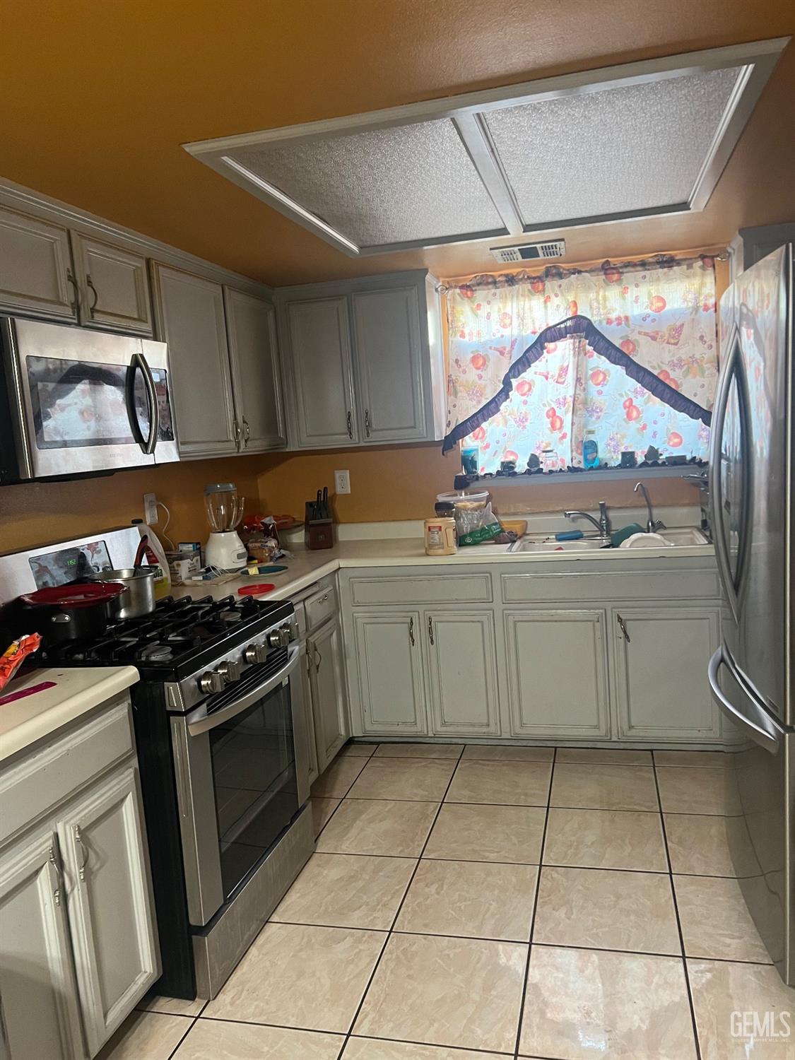 Undisclosed Address Delano, CA 93215 - Photo 2 of 8 a kitchen with a stove a sink and a refrigerator
