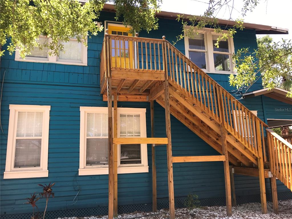 a view of front door of house with stairs