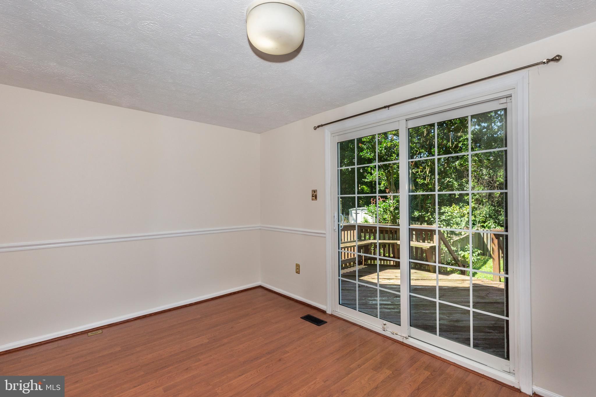 4903 Clifford Road Perry Hall, MD 21128 - Photo 11 of 30 a view of empty room with wooden floor and windows