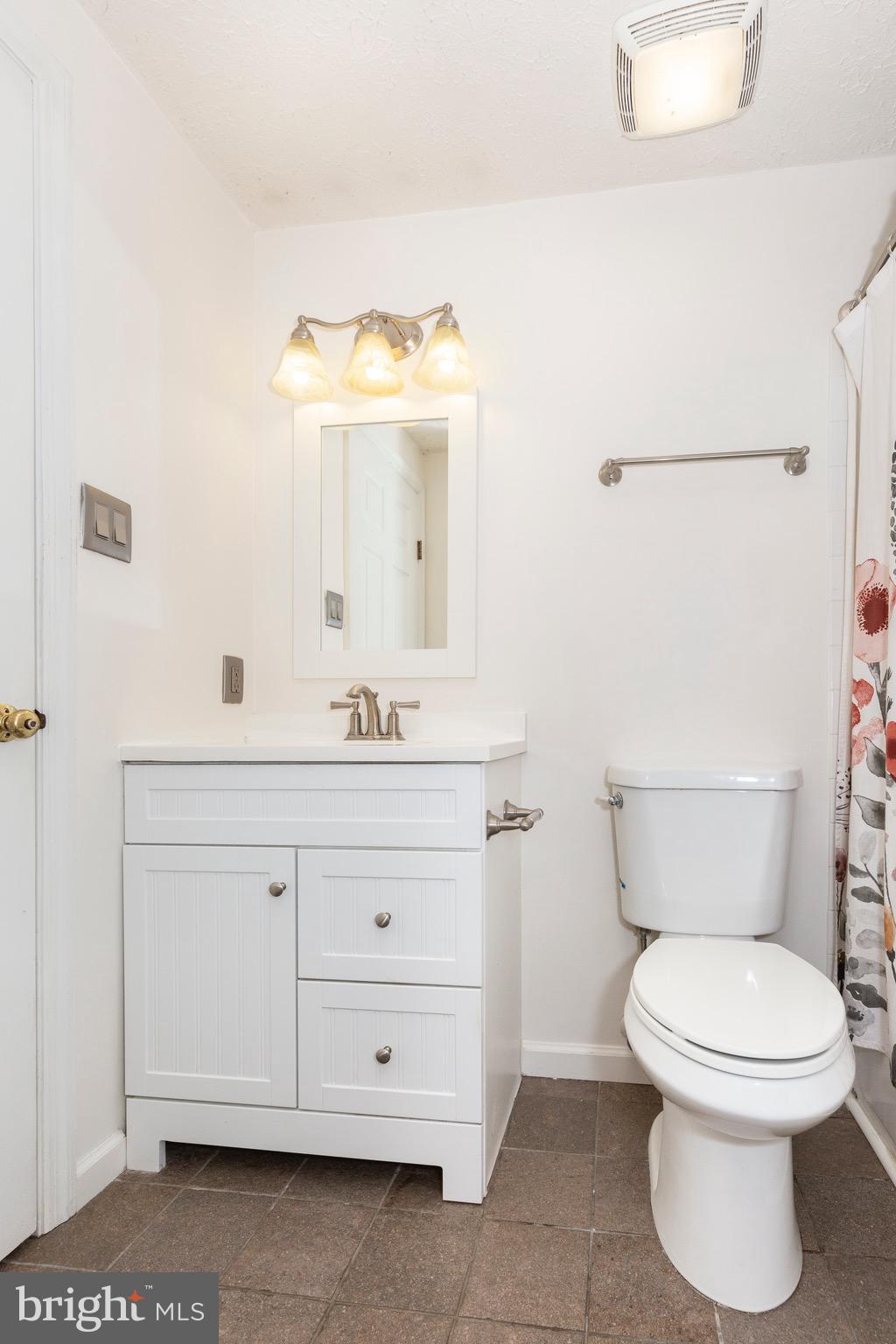 4903 Clifford Road Perry Hall, MD 21128 - Photo 20 of 30 a bathroom with a toilet a sink and mirror