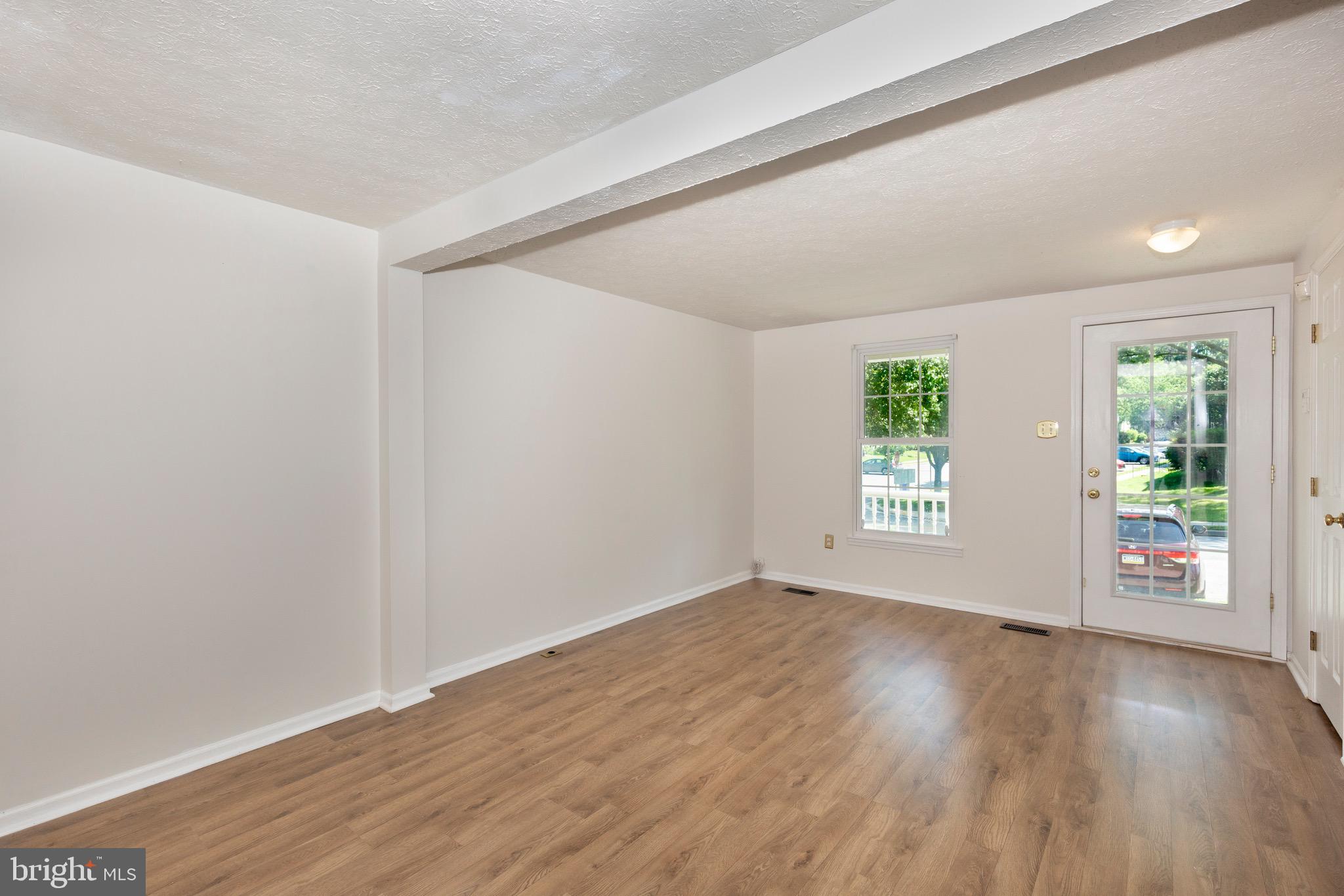 4903 Clifford Road Perry Hall, MD 21128 - Photo 5 of 30 an empty room with wooden floor and windows