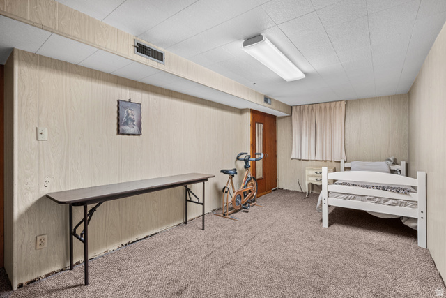 88 East C Street Springville, UT 84663 - Photo 24 of 32 Carpeted room featuring light wood-paneling walls, a drop ceiling with recessed lighting, and a window with curtains