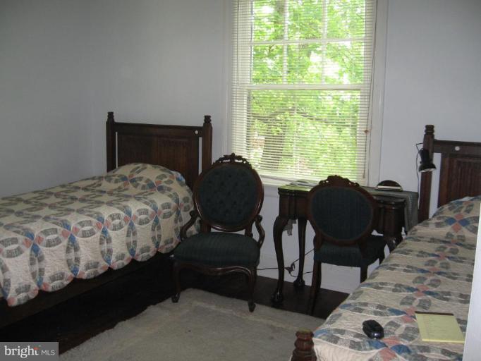 3946 Cloverhill Road Baltimore, MD 21218 - Photo 11 of 19 a bedroom with a bed chair and a window