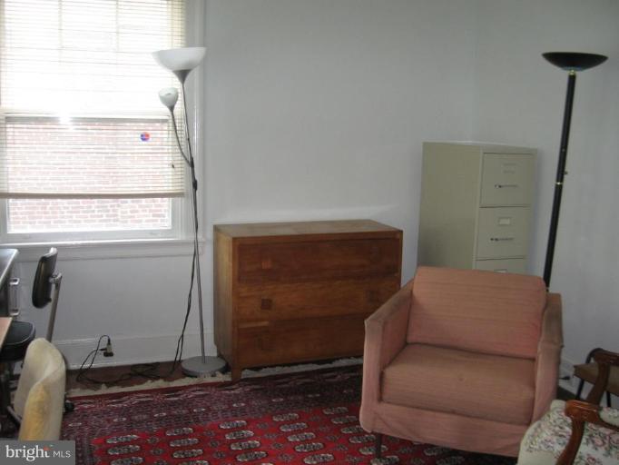3946 Cloverhill Road Baltimore, MD 21218 - Photo 12 of 19 a living room with furniture and a window