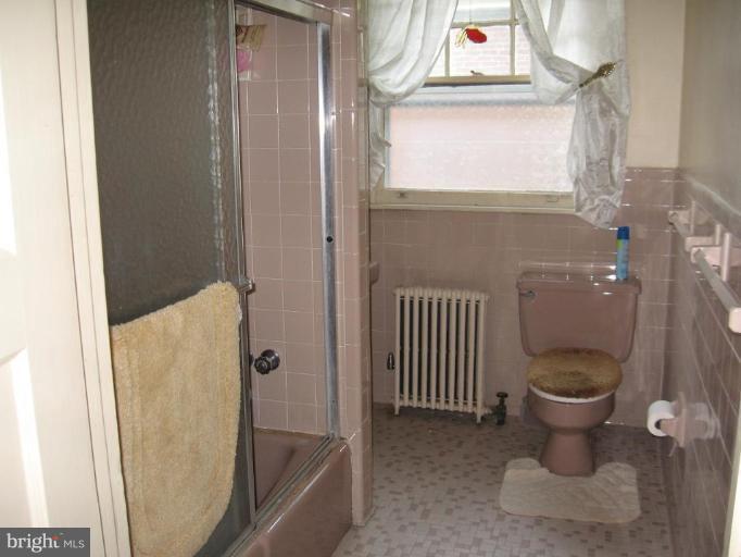 3946 Cloverhill Road Baltimore, MD 21218 - Photo 13 of 19 a bathroom with a toilet and a shower
