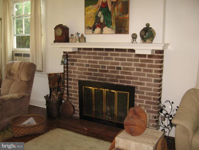 3946 Cloverhill Road Baltimore, MD 21218 - Photo 3 of 19 a living room with furniture and a fireplace