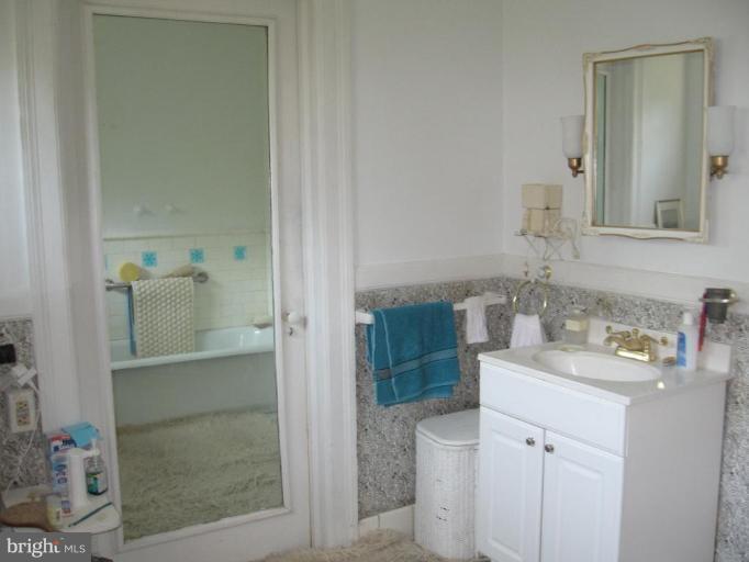 3946 Cloverhill Road Baltimore, MD 21218 - Photo 10 of 19 a bathroom with a sink and a mirror