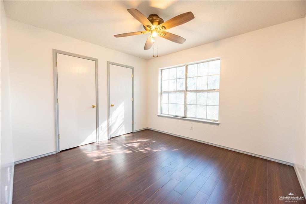 2008 West 40th Street Mission, TX 78573 - Photo 11 of 14 an empty room with wooden floor and windows
