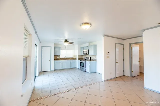 a view of a kitchen with refrigerator and windows