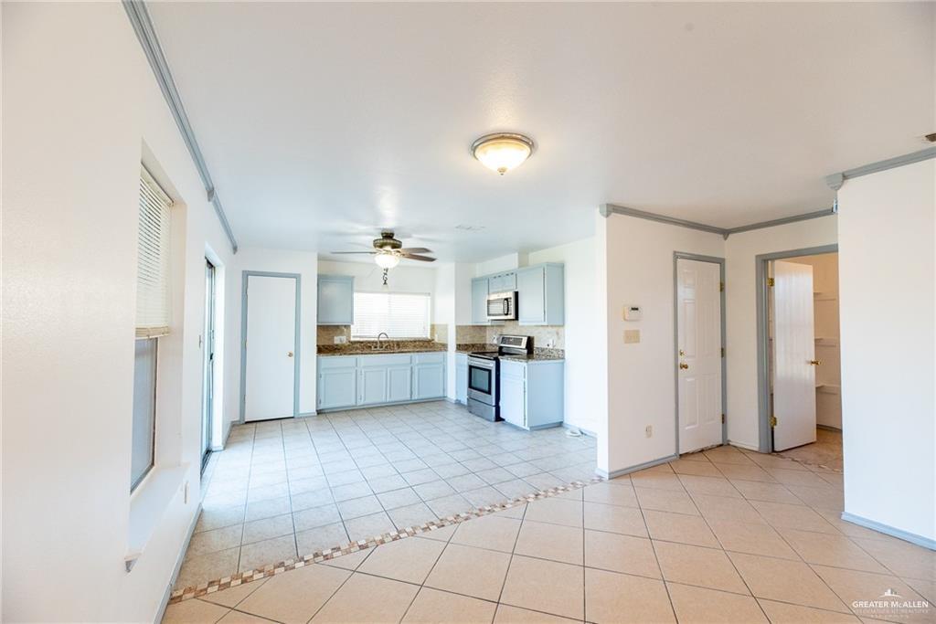 2008 West 40th Street Mission, TX 78573 - Photo 5 of 14 a view of a kitchen with refrigerator and windows