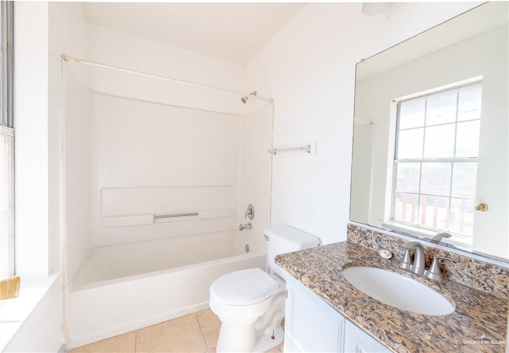 2008 West 40th Street Mission, TX 78573 - Photo 10 of 14 a bathroom with a granite countertop sink toilet and shower