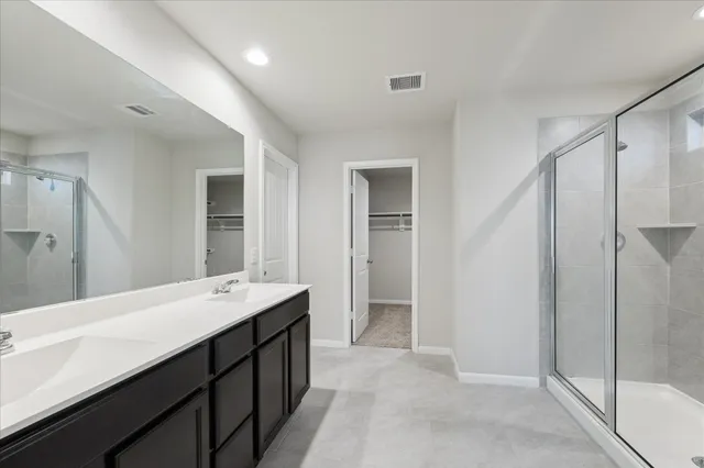a bathroom with a double vanity sink and mirror