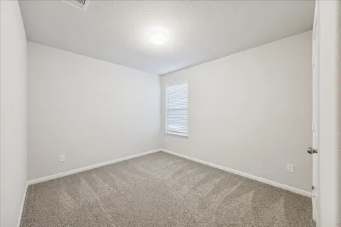 an empty room with a empty space and window