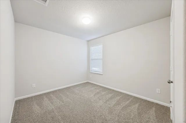 an empty room with a empty space and window