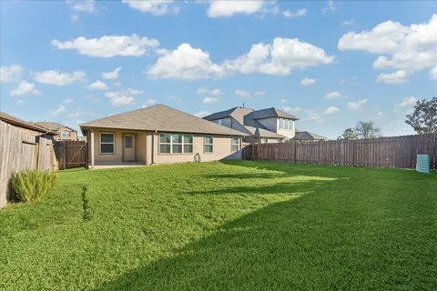 a view of a house with a big yard and a garden