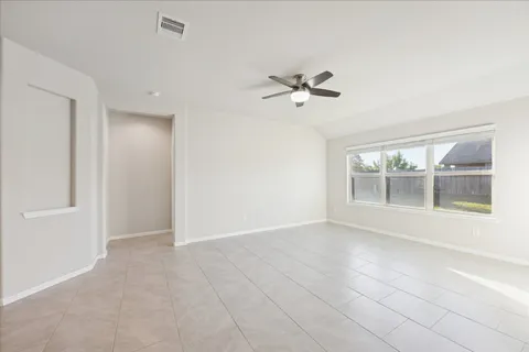 a view of room with a ceiling fan and window