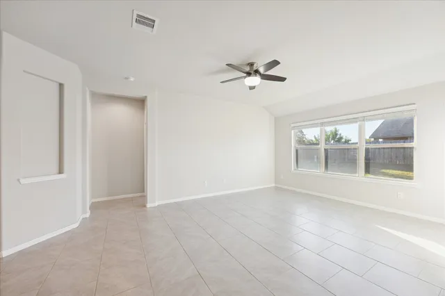 a view of room with a ceiling fan and window